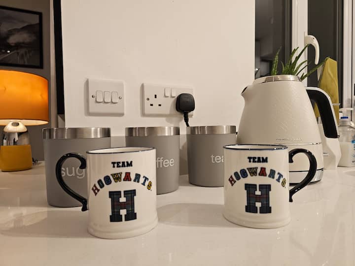 Hogwarts-themed mugs on counter